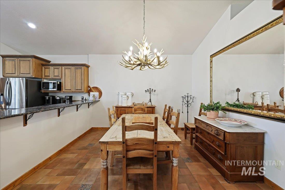 7639 Elko Lane Middleton, ID 83644 - Photo 17 of 47 Dining room with a chandelier and lofted ceiling