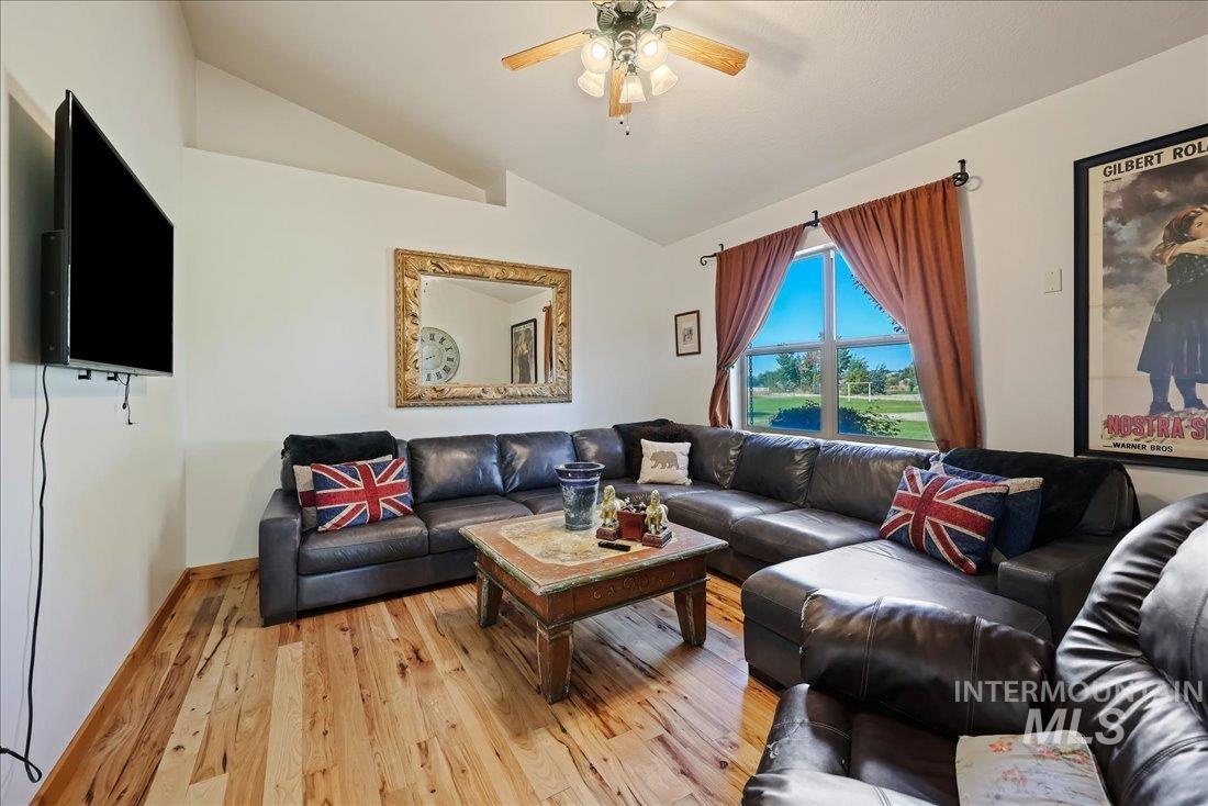 7639 Elko Lane Middleton, ID 83644 - Photo 18 of 47 Living room with light wood-type flooring, lofted ceiling, and a ceiling fan