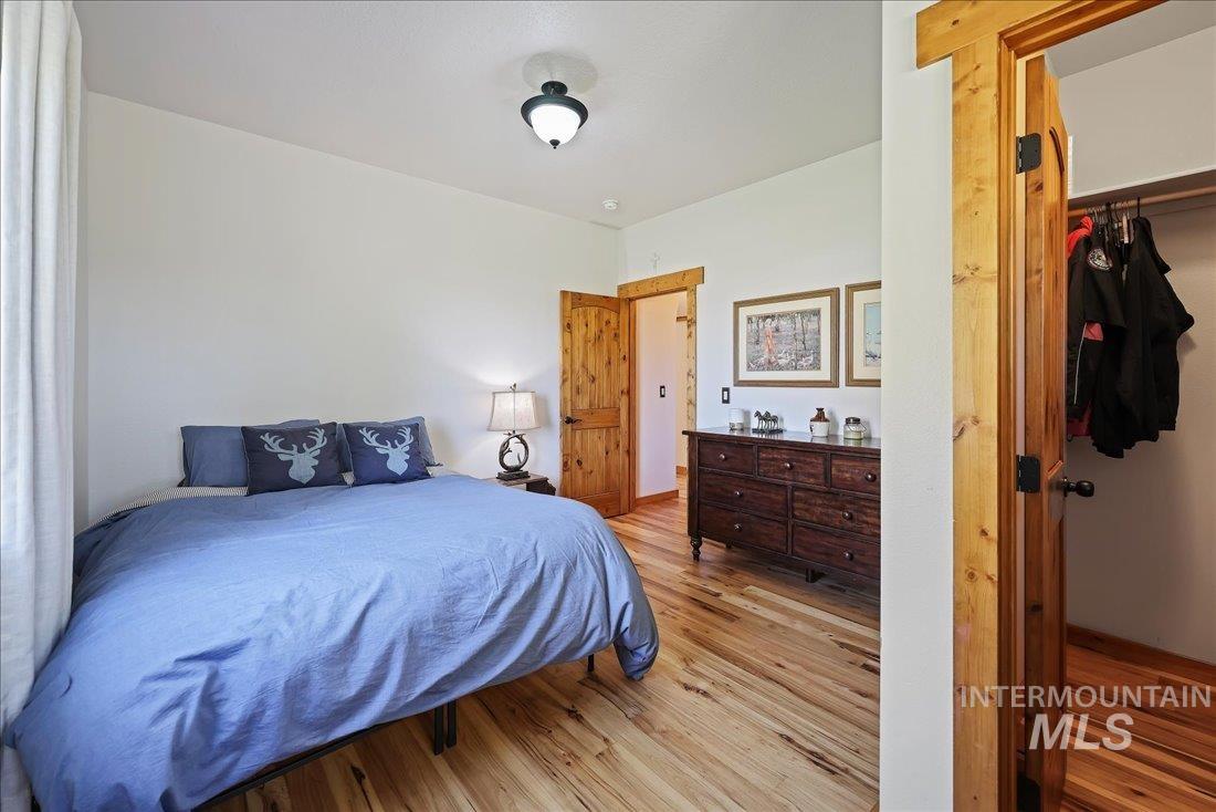 7639 Elko Lane Middleton, ID 83644 - Photo 26 of 47 Bedroom featuring wood finished floors and a walk in closet