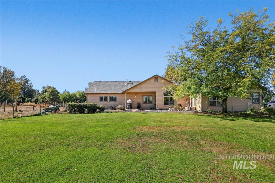 7639 Elko Lane Middleton, ID 83644 - Photo 34 of 47 Rear view of house featuring a yard and a patio area