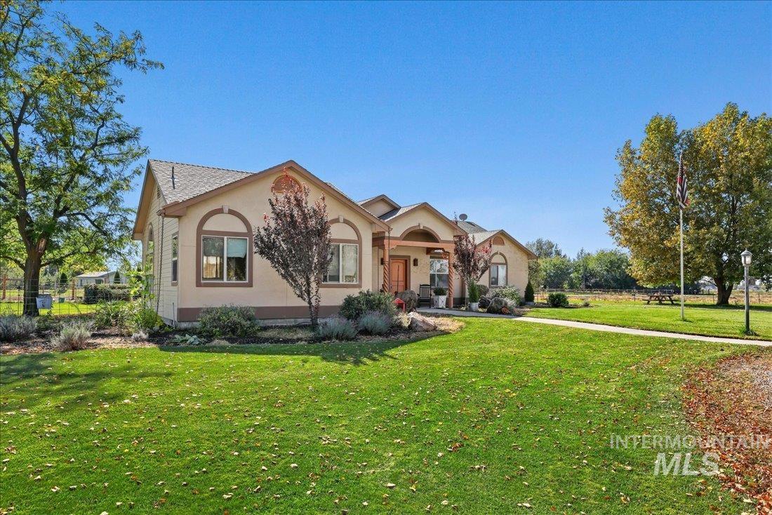 7639 Elko Lane Middleton, ID 83644 - Photo 4 of 47 View of front facade featuring a front lawn, stucco siding, and covered porch