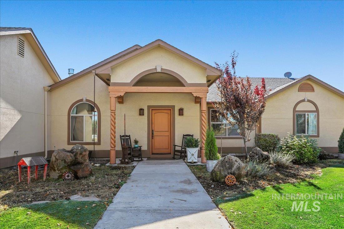7639 Elko Lane Middleton, ID 83644 - Photo 5 of 47 View of front of home featuring covered porch, stucco siding, and a front yard