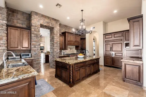 a kitchen with stainless steel appliances granite countertop a stove and a wooden cabinets