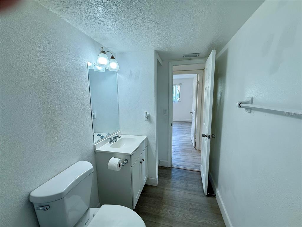 900 North Lake Destiny Road, Unit A Altamonte Springs, FL 32714 - Photo 17 of 26 a bathroom with a granite countertop toilet a sink and a mirror