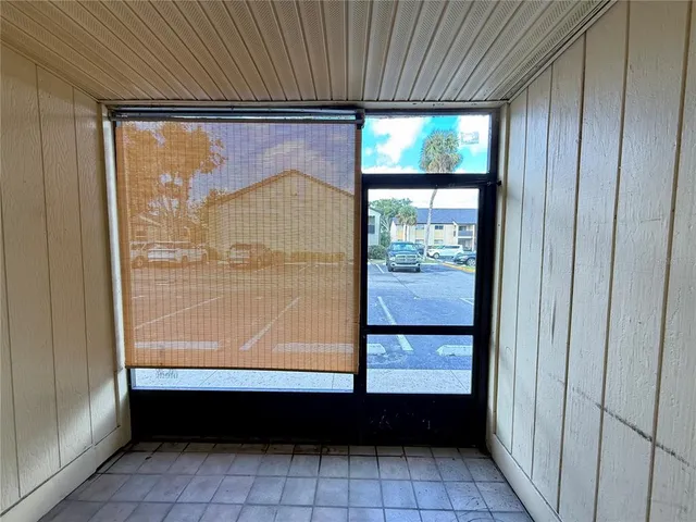 a room with a large window and front door