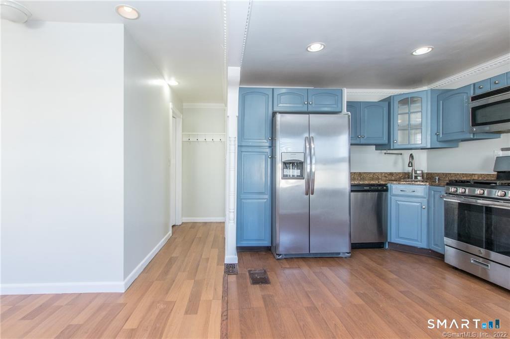 18 Lawrence Street Norwalk, CT 06854 - Photo 17 of 31 a kitchen with kitchen island a counter top space a sink and stainless steel appliances