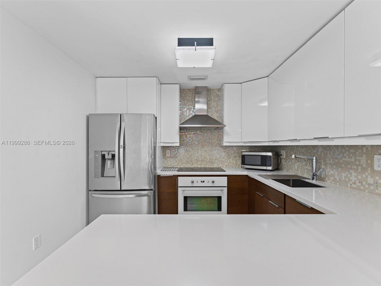 13404 Southwest 153 Terrace, Unit 2005 Miami, FL 33177 - Photo 21 of 49 a kitchen with stainless steel appliances a refrigerator sink and stove