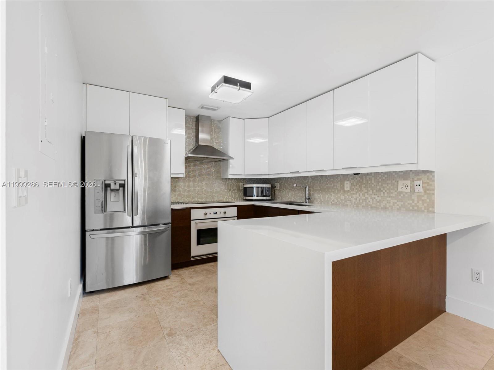 13404 Southwest 153 Terrace, Unit 2005 Miami, FL 33177 - Photo 22 of 49 a kitchen with stainless steel appliances a refrigerator sink and microwave