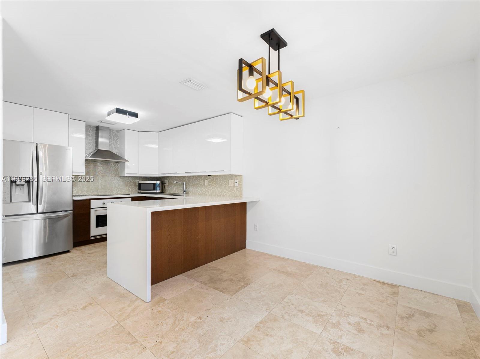 13404 Southwest 153 Terrace, Unit 2005 Miami, FL 33177 - Photo 23 of 49 a kitchen with a refrigerator and a stove