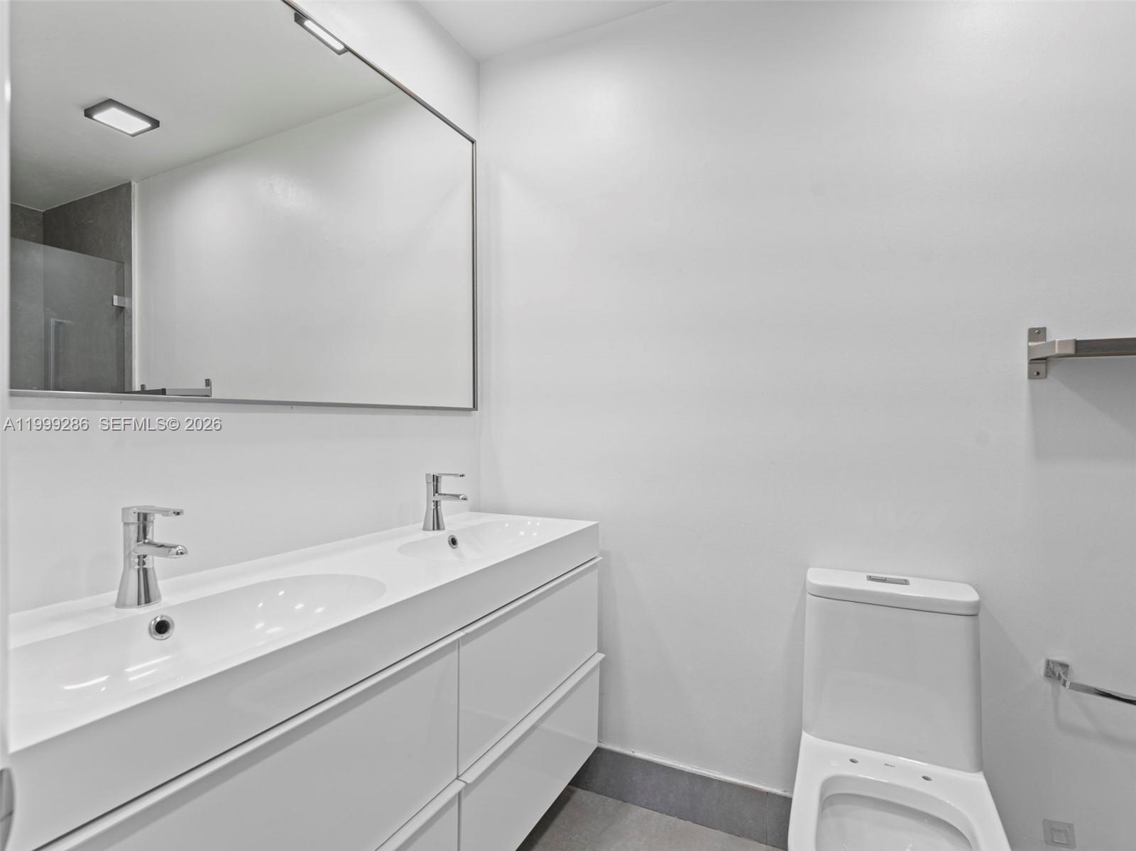 13404 Southwest 153 Terrace, Unit 2005 Miami, FL 33177 - Photo 29 of 49 a bathroom with a sink mirror and toilet