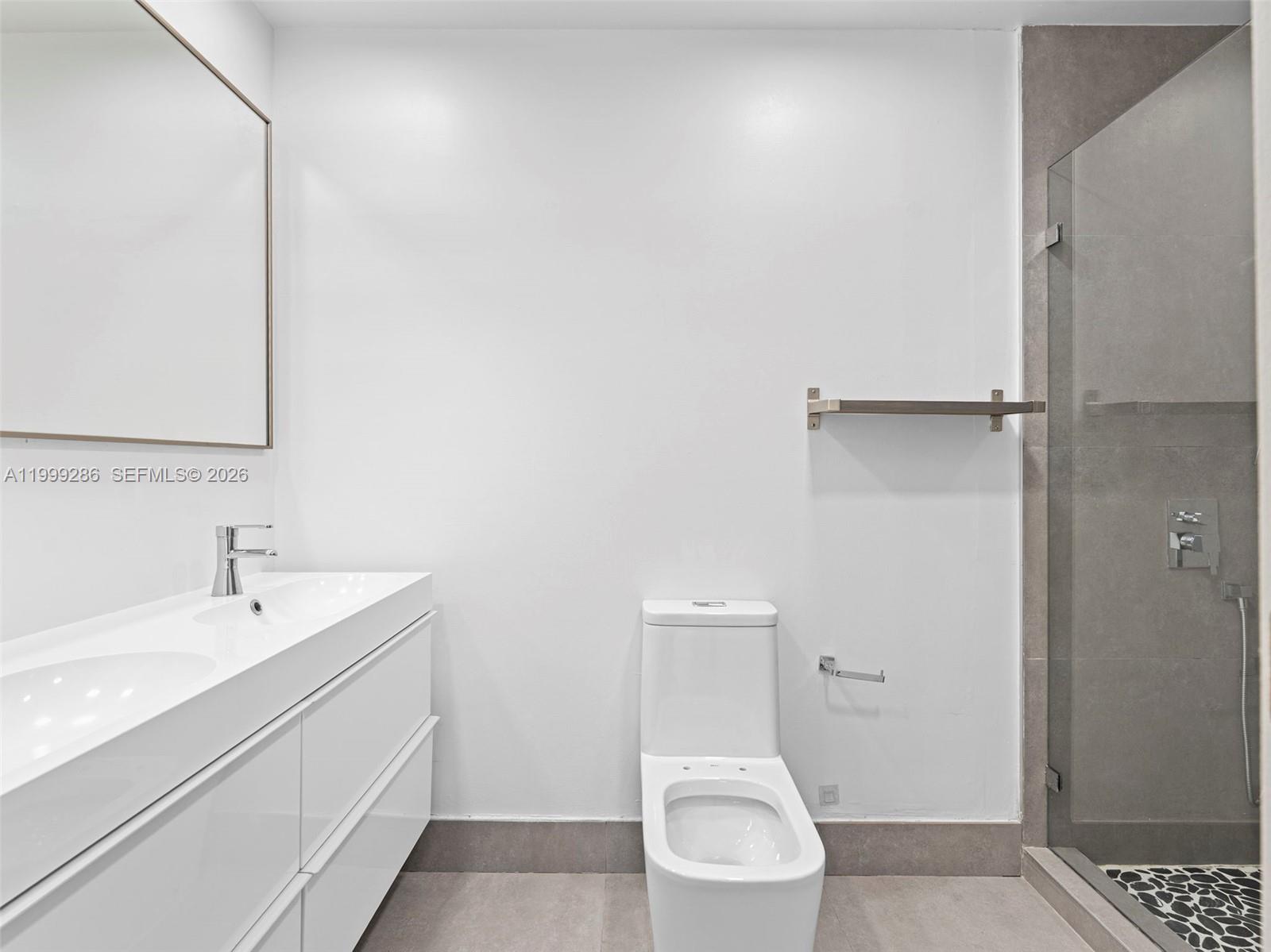 13404 Southwest 153 Terrace, Unit 2005 Miami, FL 33177 - Photo 30 of 49 a white toilet sitting next to a bathroom sink