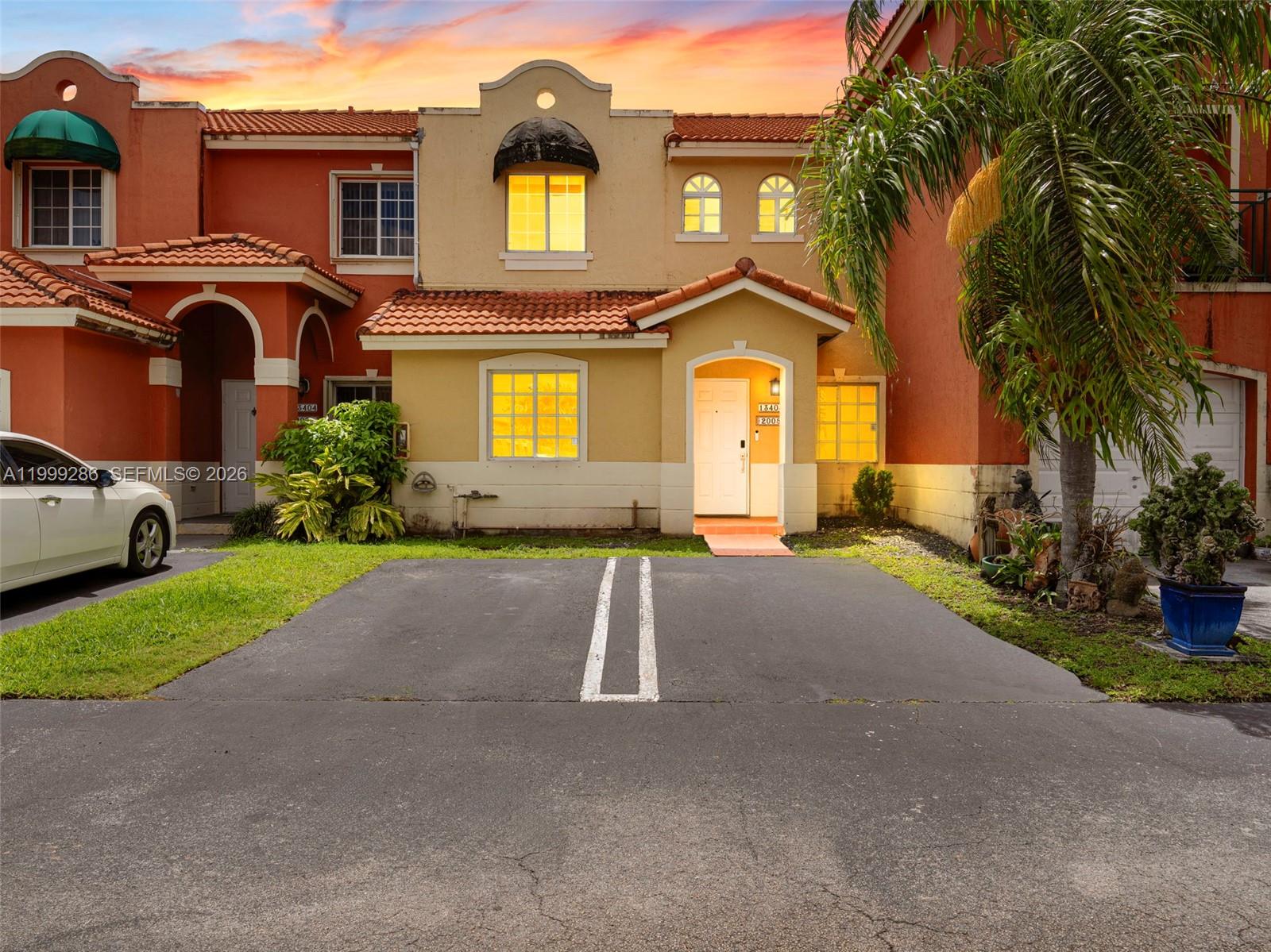13404 Southwest 153 Terrace, Unit 2005 Miami, FL 33177 - Photo 3 of 49 a front view of a house with a yard and garage