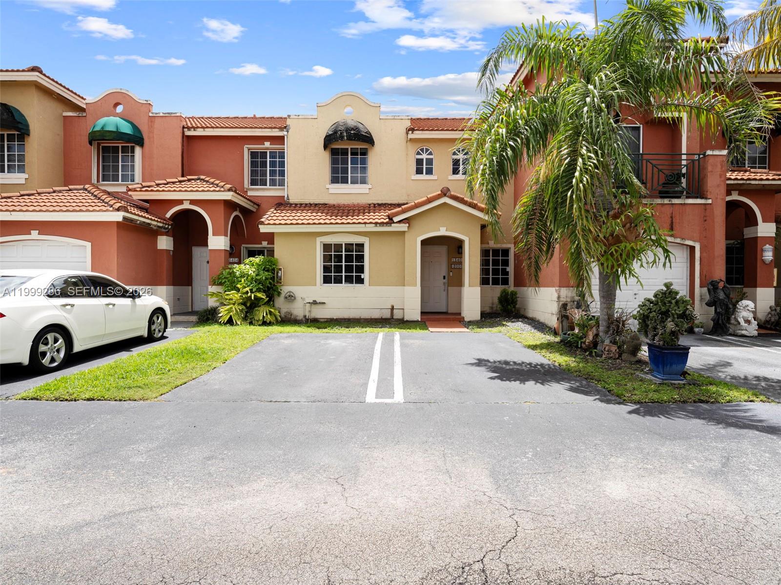 13404 Southwest 153 Terrace, Unit 2005 Miami, FL 33177 - Photo 38 of 49 a front view of a house with a yard and garage