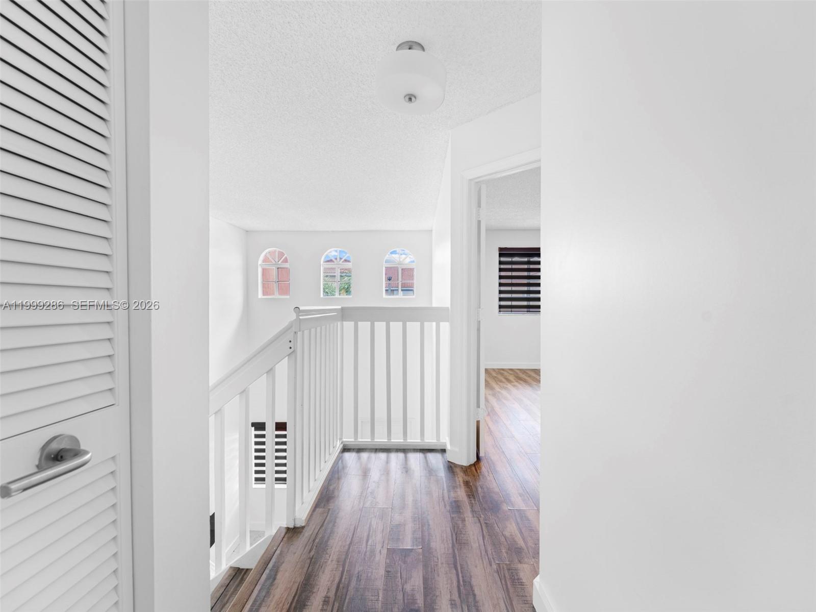 13404 Southwest 153 Terrace, Unit 2005 Miami, FL 33177 - Photo 39 of 49 a view of a hallway with wooden floor and staircase