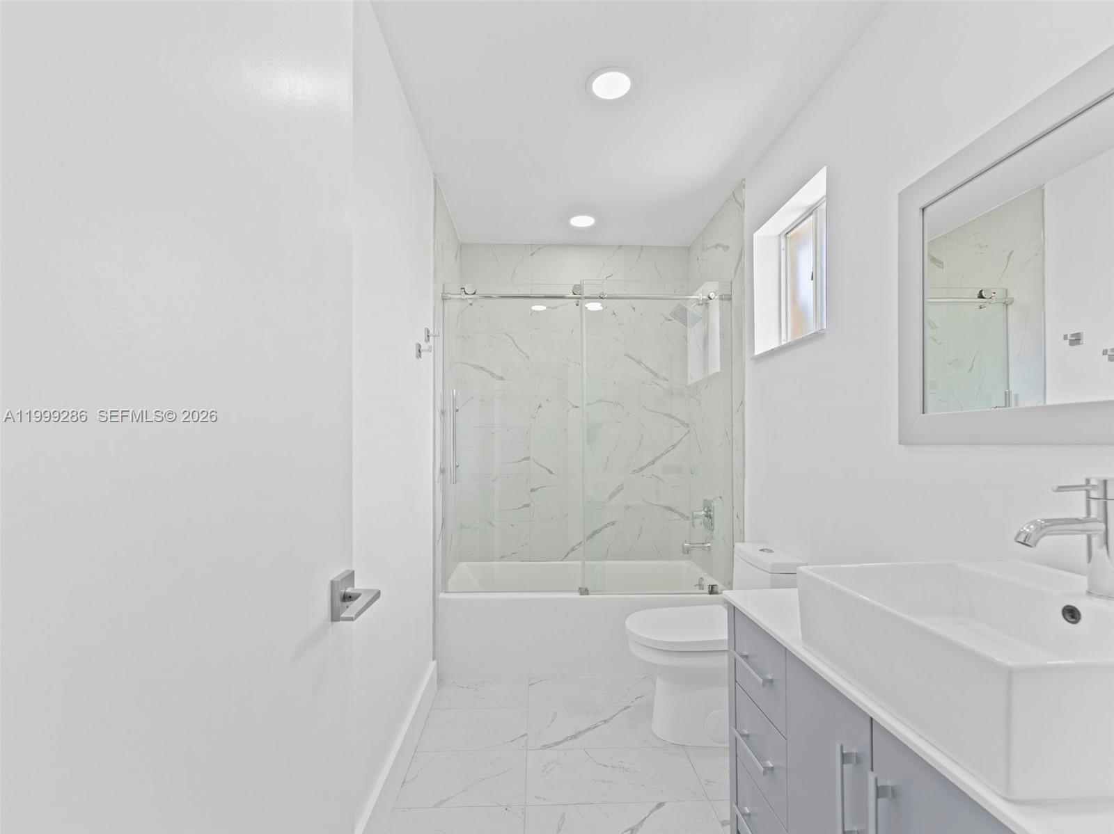 13404 Southwest 153 Terrace, Unit 2005 Miami, FL 33177 - Photo 41 of 49 a bathroom with a bathtub shower sink mirror and toilet