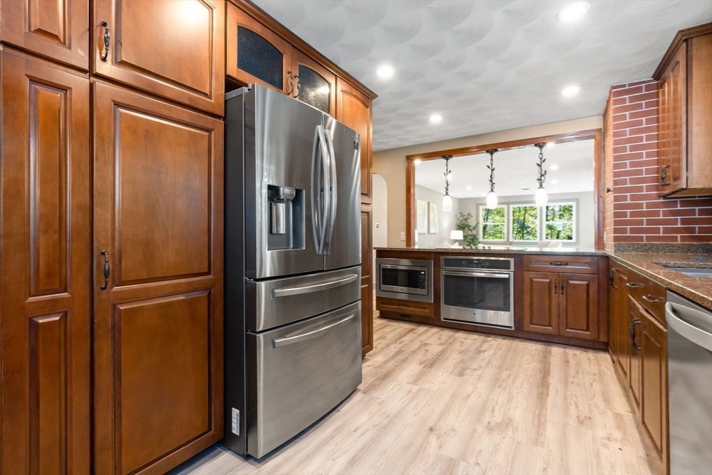 97 Oak Street Stoneham, MA 02180 - Photo 20 of 42 a kitchen with stainless steel appliances a refrigerator sink and cabinets