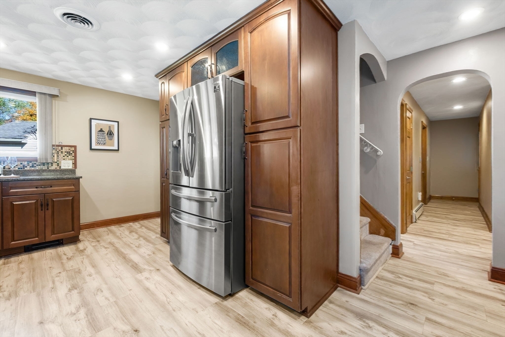97 Oak Street Stoneham, MA 02180 - Photo 22 of 42 a kitchen with stainless steel appliances granite countertop a refrigerator and a stove