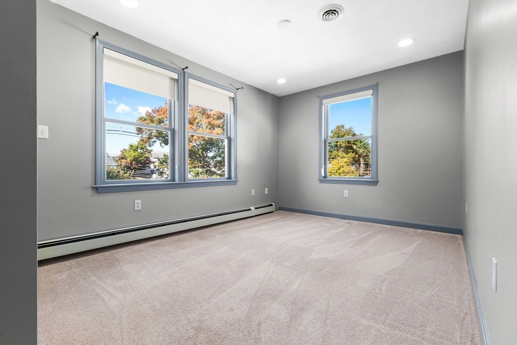 97 Oak Street Stoneham, MA 02180 - Photo 34 of 42 an empty room with windows and wall