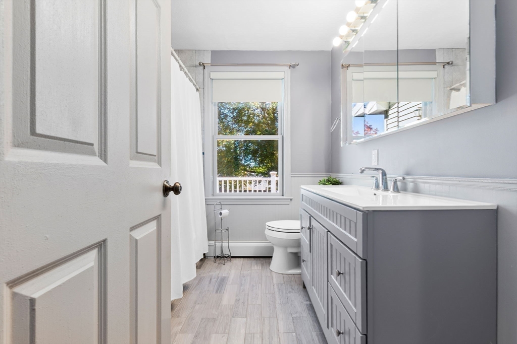 97 Oak Street Stoneham, MA 02180 - Photo 35 of 42 a bathroom with a sink a toilet and a mirror