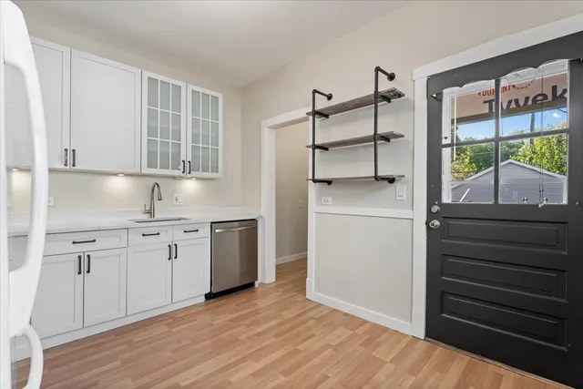 a kitchen with a refrigerator and a sink