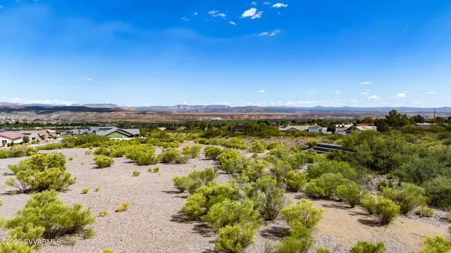 an aerial view of a city with lots of residential buildings ocean and mountain view in back