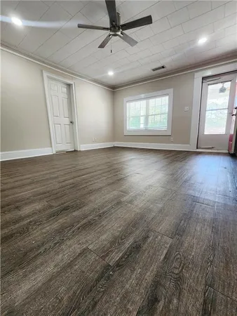 a view of a hallway with wooden floor
