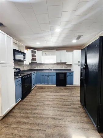 a view of kitchen stove microwave and cabinets