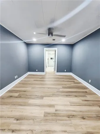 a kitchen with kitchen island white cabinets and black appliances