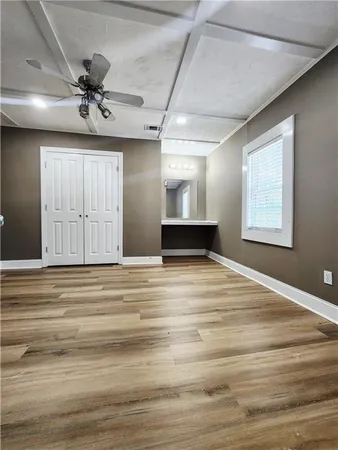 a view of empty room with wooden floor