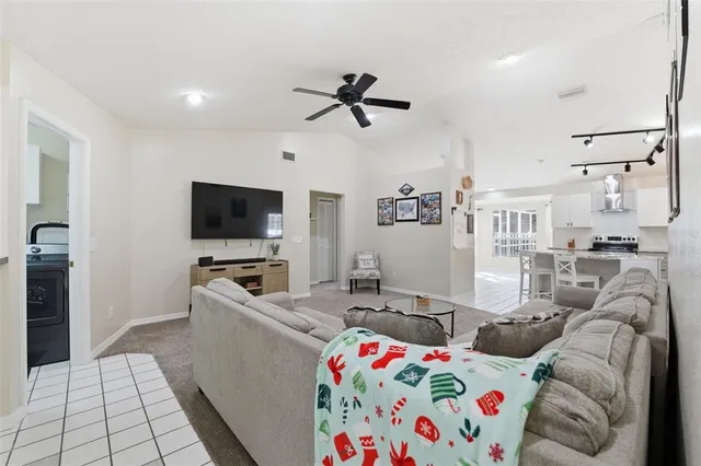 a living room with furniture and a baby crib