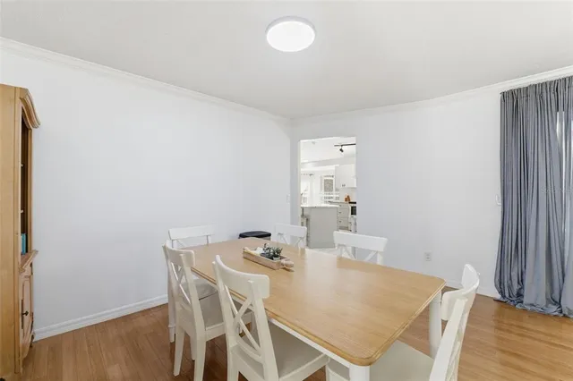 a view of a backyard with table and chairs under an umbrella