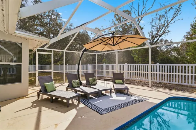 a dining room with furniture and a floor to ceiling window
