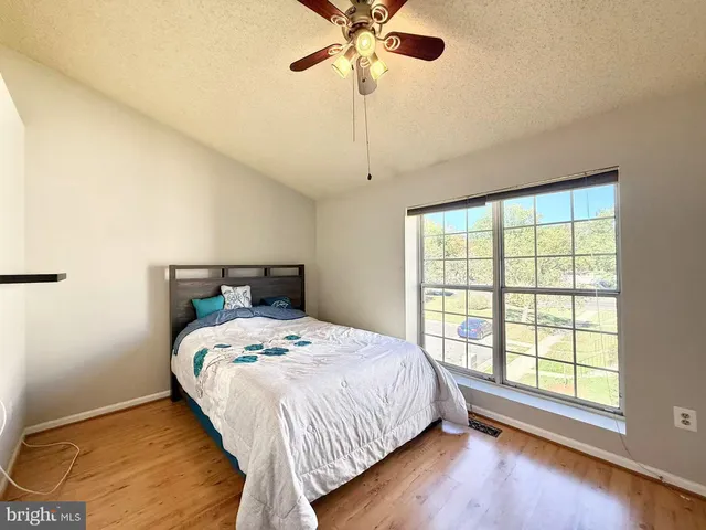a bedroom with a bed and a large window