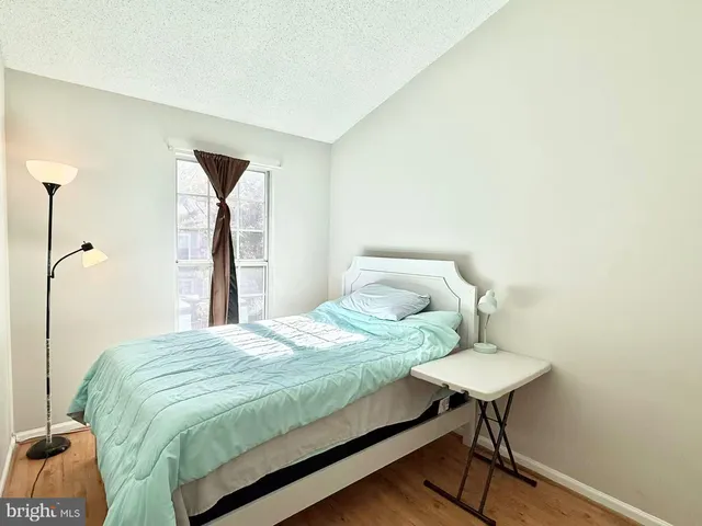 a bedroom with a bed and a table in it