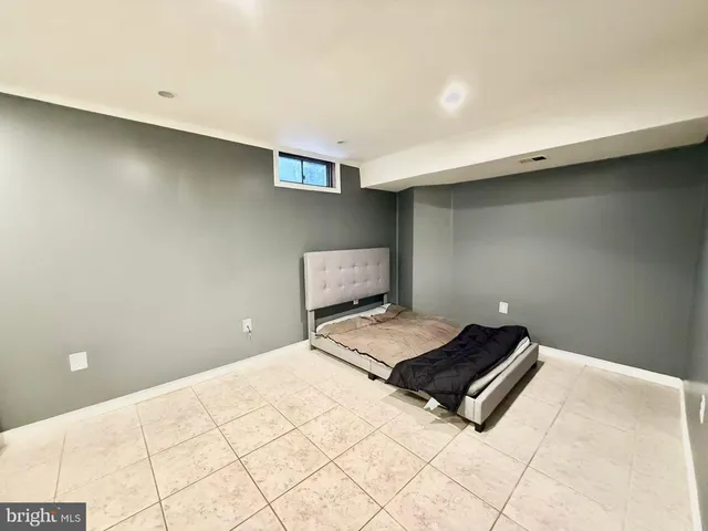 a bedroom with a bed and a night stand