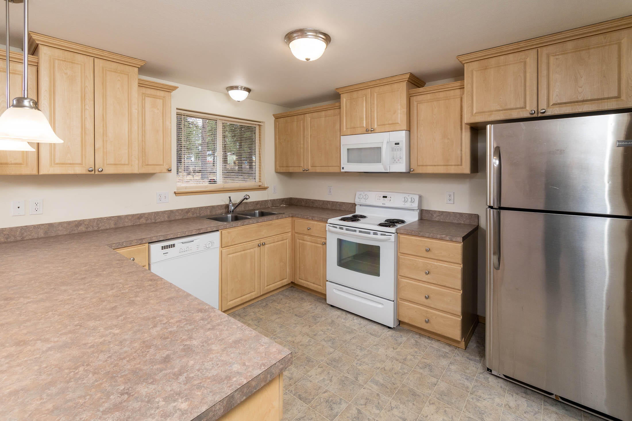 60196 Navajo Road Bend, OR 97702 - Photo 7 of 23 Large kitchen includes all appliances. Large breakfast bar in this kitchen is so handy. The window overlooks the back yard.
