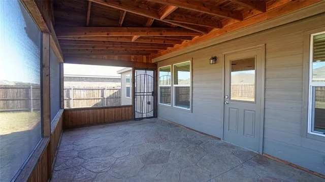 a big room with wooden walls and windows