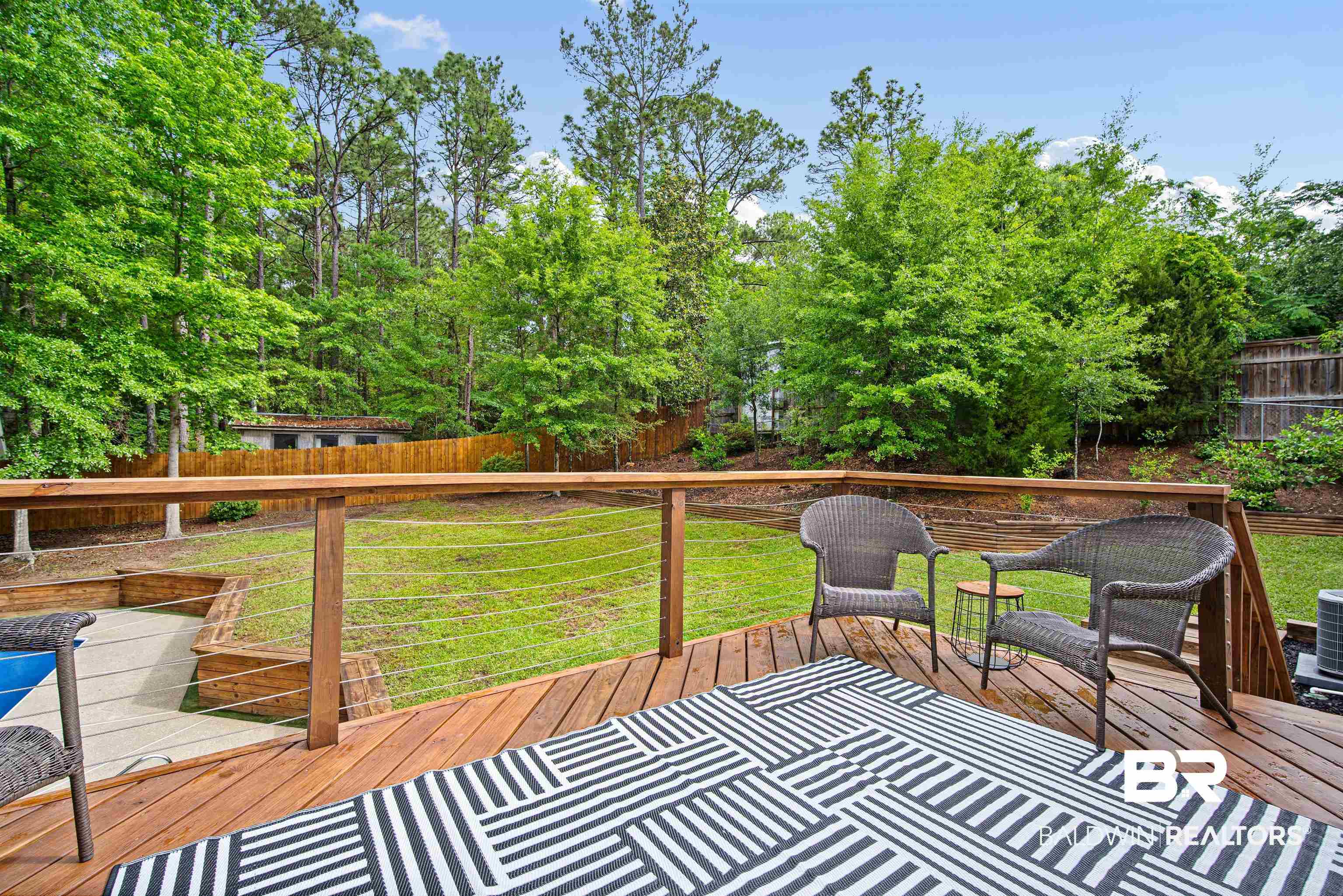 71 Caisson Trace Daphne, AL 36527 - Photo 25 of 36 Wood deck featuring a cable railing system, overlooking a grassy yard with mature trees