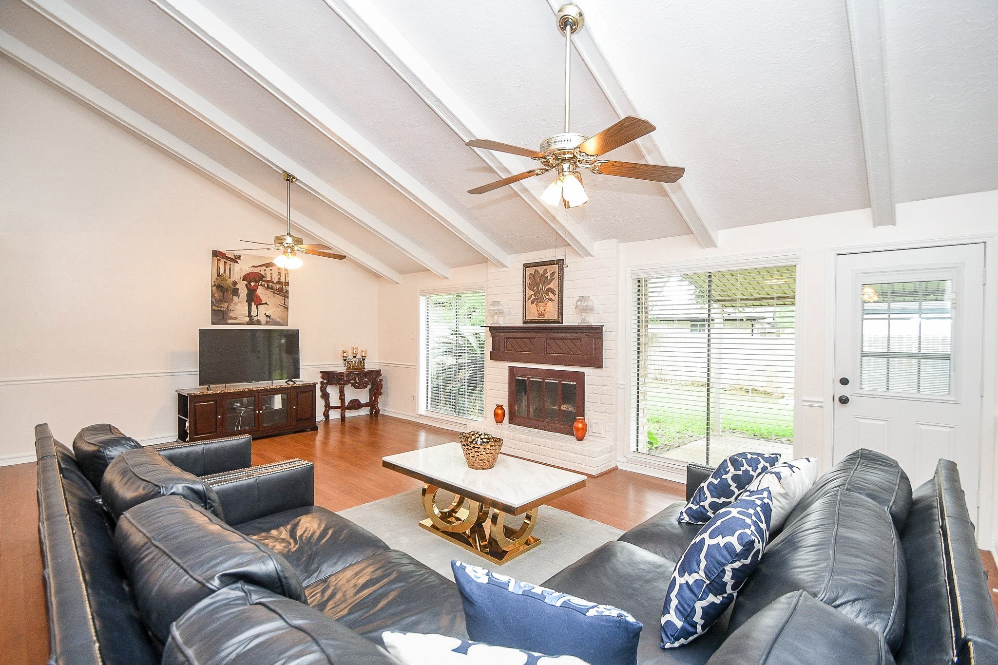 11635 Sagevale Lane Houston, TX 77089 - Photo 14 of 32 The spectacular planked ceiling lends a rustic charm to this casual family area, with easy to handle floor-to-ceiling windows and handy patio door, up right. Imagine holiday time in this space, with loved ones gathered 'round the attractive built-in fireplace.