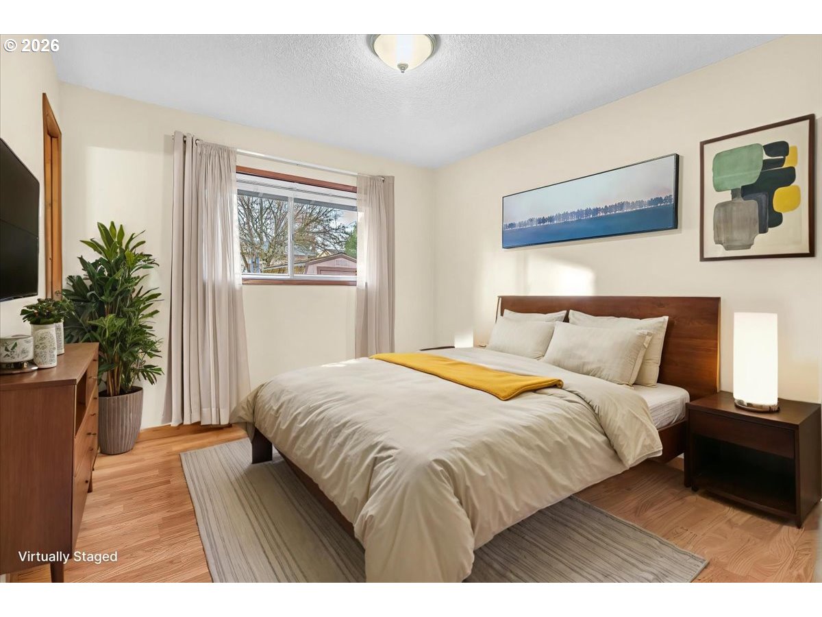 2775 Southwest 182nd Avenue Beaverton, OR 97003 - Photo 12 of 35 a bedroom with a large bed and a window