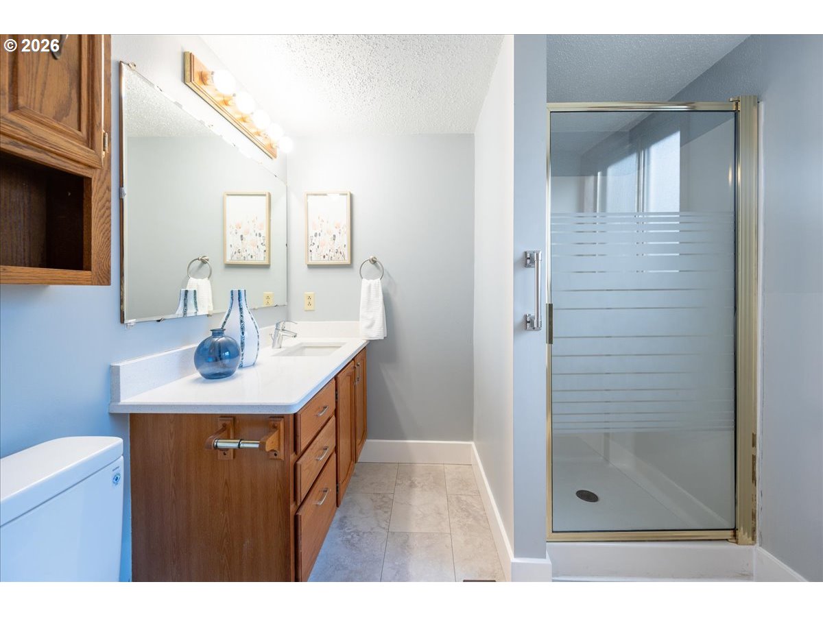 2775 Southwest 182nd Avenue Beaverton, OR 97003 - Photo 13 of 35 a bathroom with a sink a mirror and shower