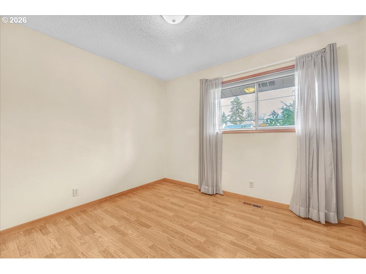 2775 Southwest 182nd Avenue Beaverton, OR 97003 - Photo 15 of 35 an empty room with wooden floor and windows