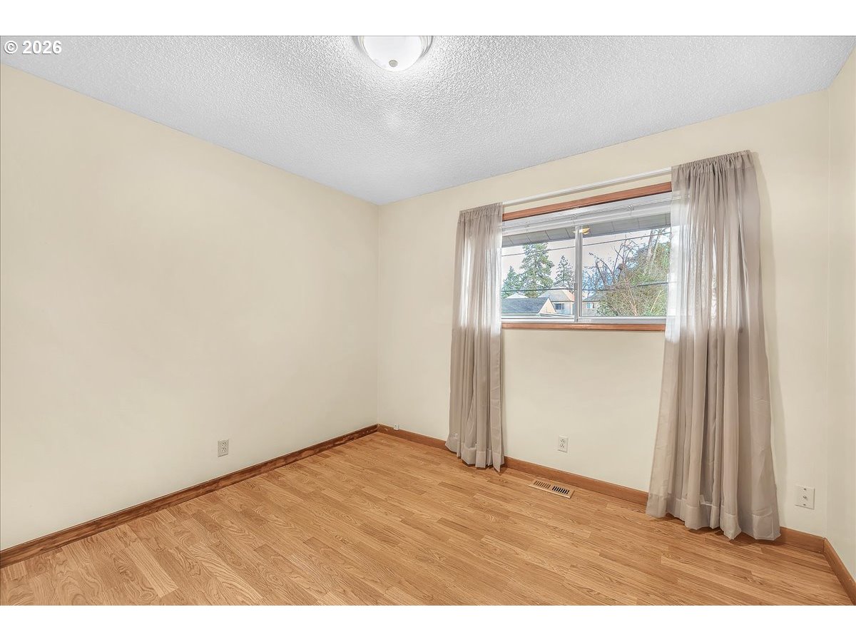 2775 Southwest 182nd Avenue Beaverton, OR 97003 - Photo 18 of 35 an empty room with wooden floor and windows