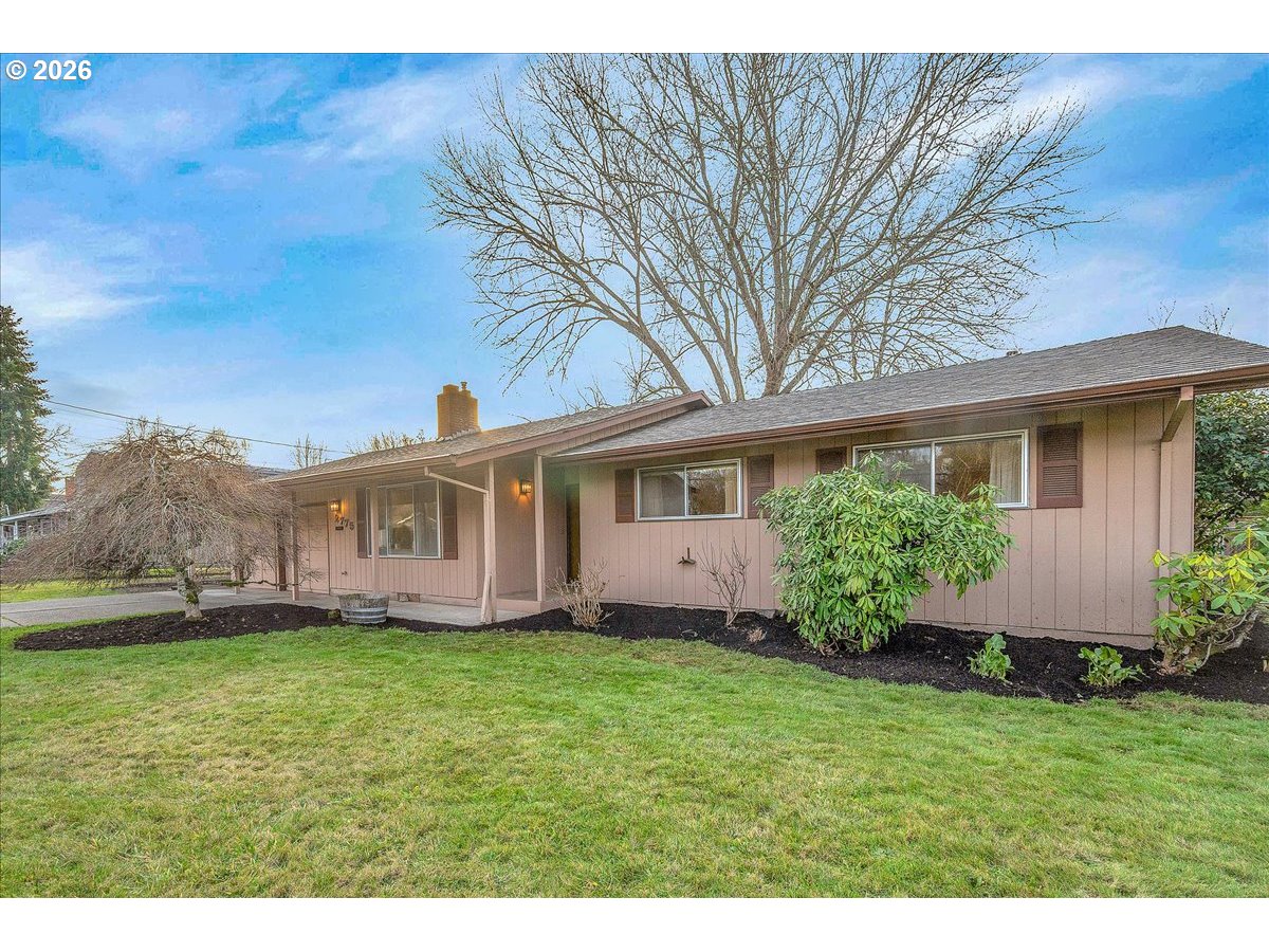 2775 Southwest 182nd Avenue Beaverton, OR 97003 - Photo 2 of 35 a front view of a house with a garden and yard