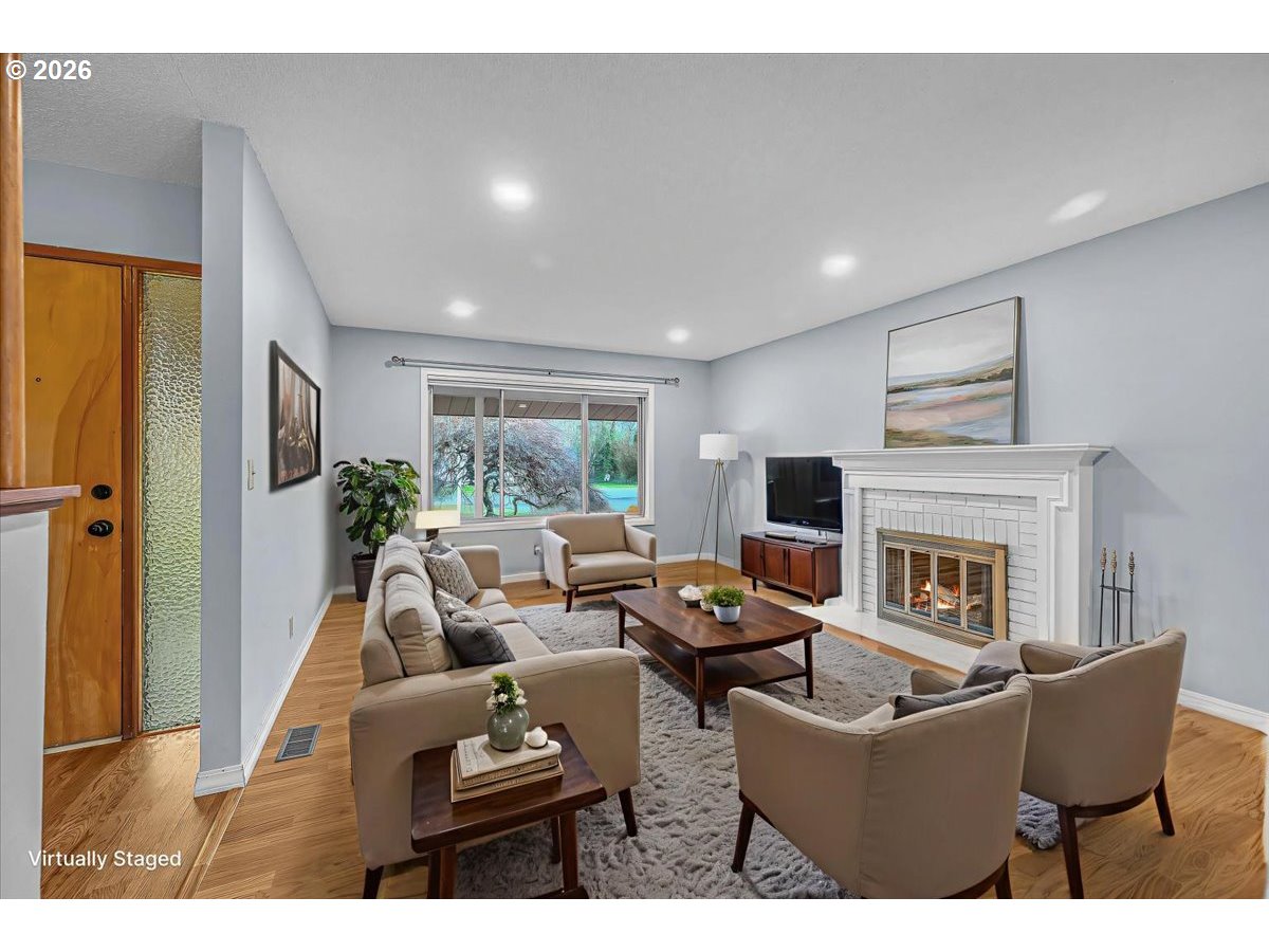 2775 Southwest 182nd Avenue Beaverton, OR 97003 - Photo 5 of 35 a living room with furniture fireplace and a large window