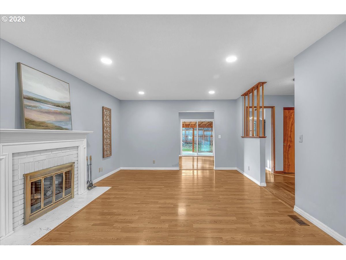 2775 Southwest 182nd Avenue Beaverton, OR 97003 - Photo 6 of 35 a view of empty room with wooden floor and fireplace