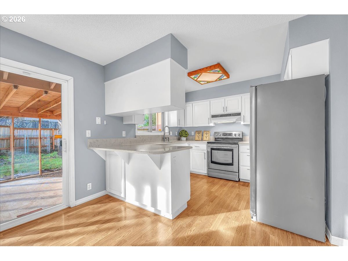 2775 Southwest 182nd Avenue Beaverton, OR 97003 - Photo 9 of 35 a kitchen with stainless steel appliances granite countertop a stove a sink and a refrigerator