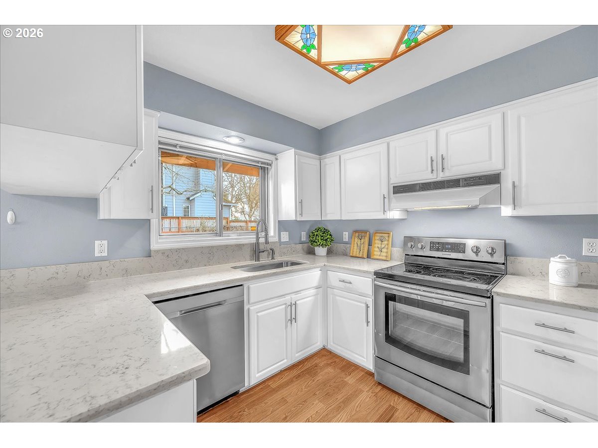 2775 Southwest 182nd Avenue Beaverton, OR 97003 - Photo 10 of 35 a kitchen with a stove a sink and a window