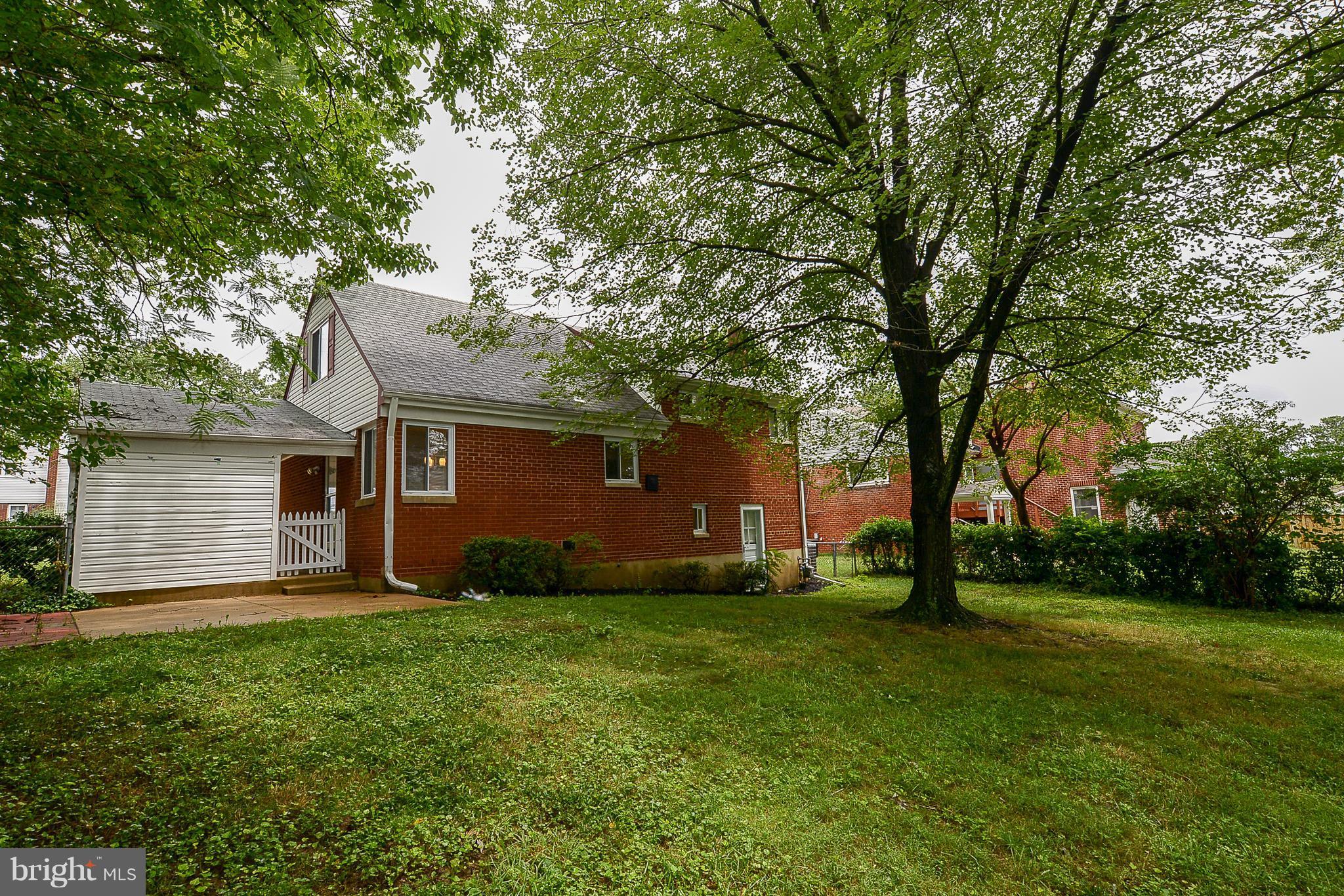 7106 Reservoir Road Springfield, VA 22150 - Photo 2 of 18 a view of a backyard with a large tree