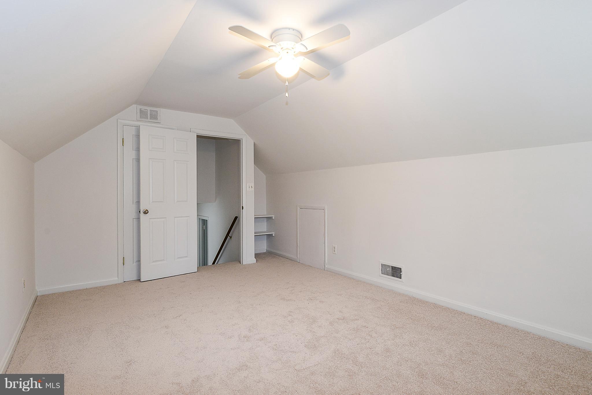 7106 Reservoir Road Springfield, VA 22150 - Photo 13 of 18 an empty room with a ceiling fan and a window